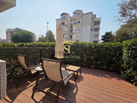 Wooden terrace with sun loungers and a view of the building. - image 14