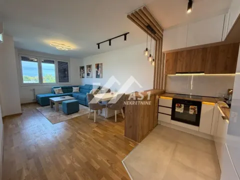 Open-plan living room with kitchen and dining area. - image 9