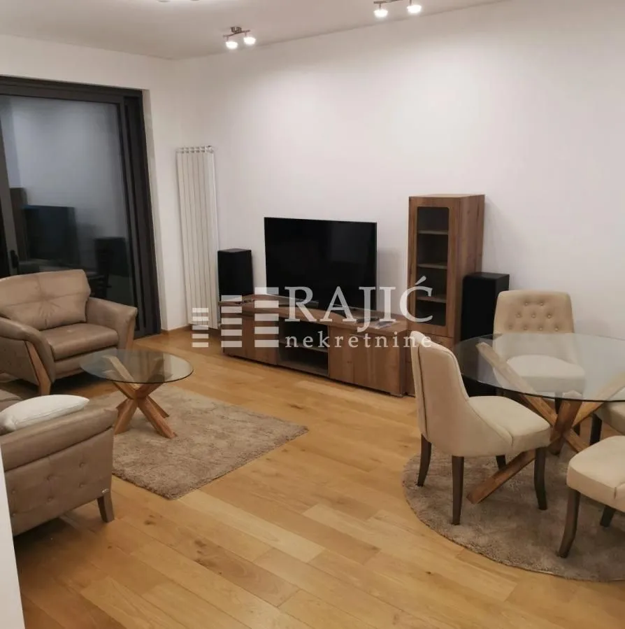 Living room with a sofa set and a dining table.