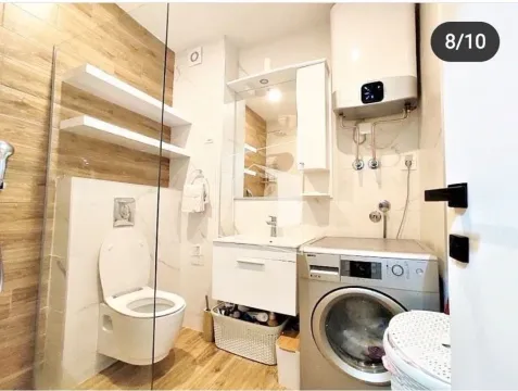 Bathroom equipped with sanitary fixtures, walk-in shower, washbasin, and washing machine. - image 6
