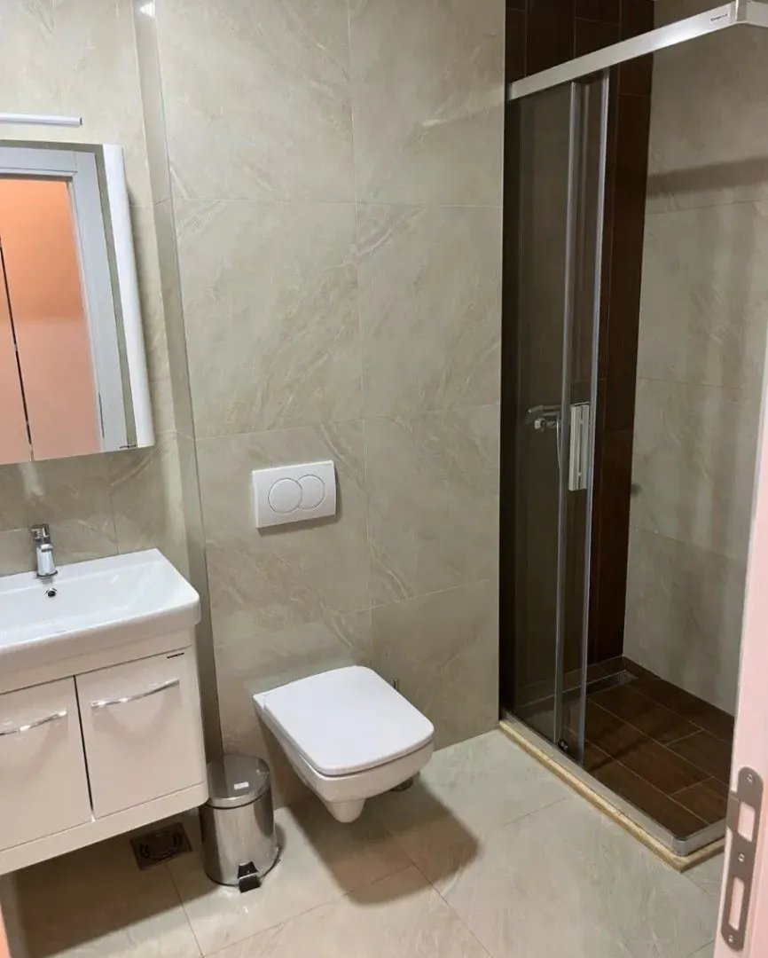 Modern bathroom with a shower cabin and washbasin.