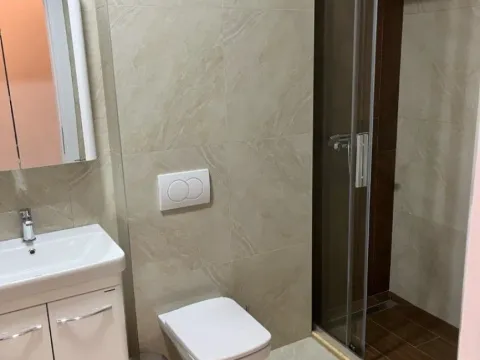 Modern bathroom with a shower cabin and washbasin. - image 2