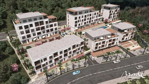 Pogled iz vazduha na kompleks zgrada sa uređenim dvorištem i zelenilom. - image 6