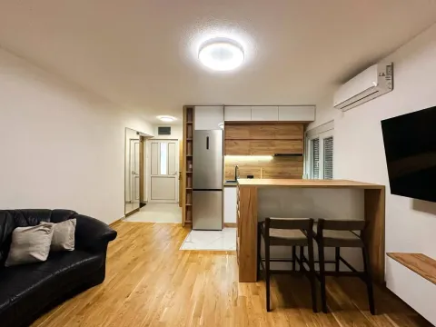 Modern living room connected to the kitchen and a bar counter. - image 6