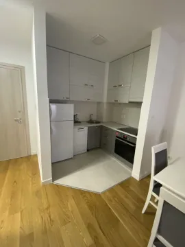 Small, modern kitchen with white appliances and light cabinetry. - image 6