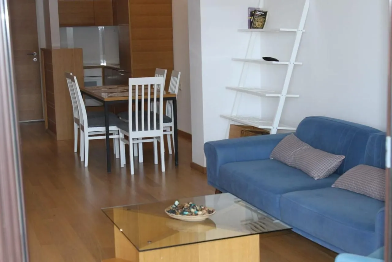 Living room with sofa and dining area.