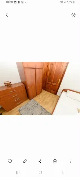 Small bedroom with a bed, wooden wardrobe and dresser. - image 13