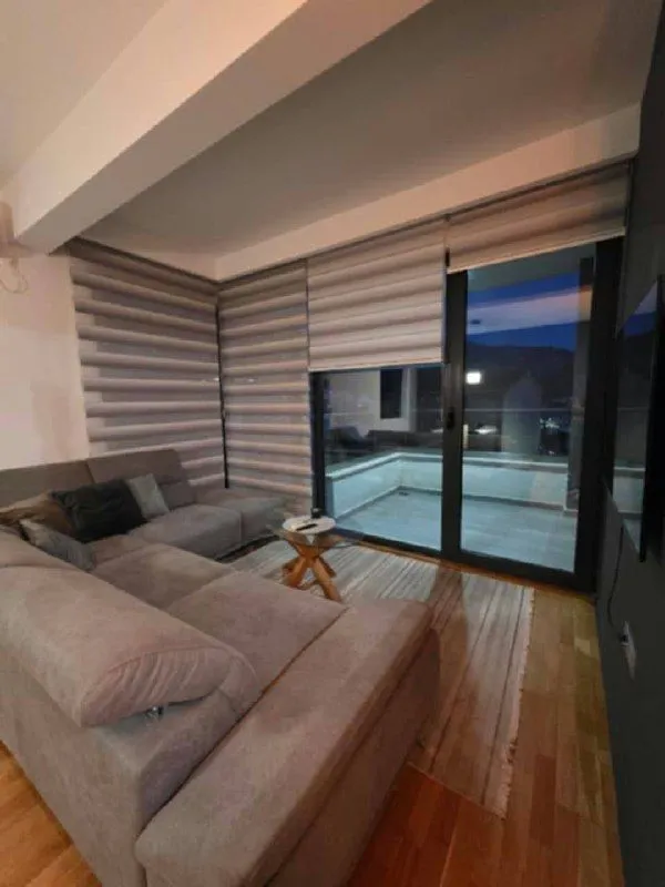 Living room with a sectional sofa and access to the terrace.