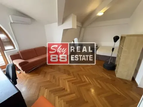 Living room with a sofa, bed, and wooden flooring. - image 19