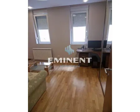 Living room with a sofa, desk and parquet flooring. - image 10