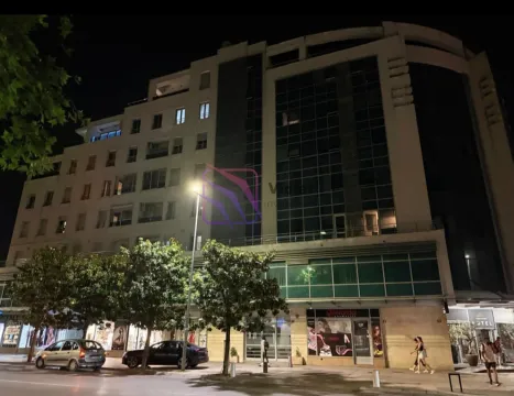 Noćni pogled na spoljašnjost višestambene zgrade sa poslovnim prostorima u prizemlju. - image 2
