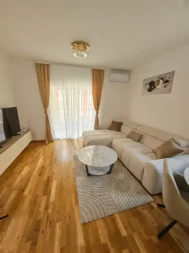 Furnished living room with a sofa, coffee table, and television. - image 5