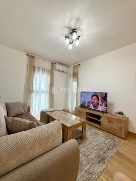 Living room with sofa, coffee table and TV unit. - image 2
