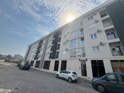 Exterior view of a modern residential building with parking. - image 9