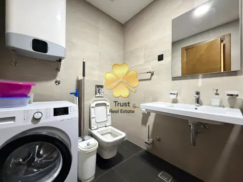 Modernly equipped bathroom with a washing machine. - image 9