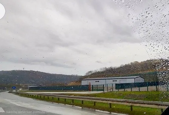 View of the exterior of the property through a wet vehicle window.