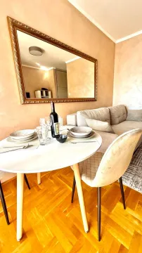 Living room with a dining table and sofa. - image 7