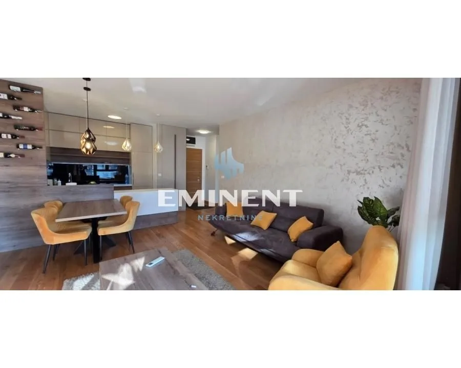 Living room connected to the dining area and kitchen in an open space layout.