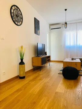 Moderan i svetao dnevni boravak sa drvenim podom i televizorom. - image 4