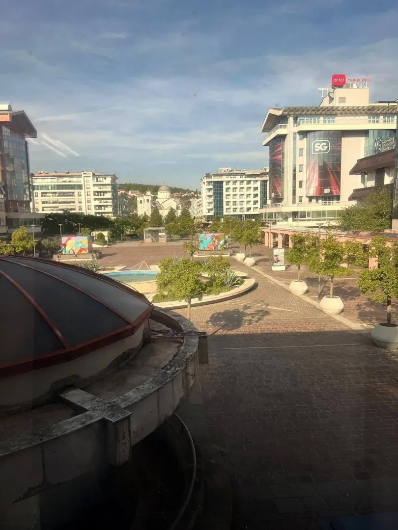 View from the window of the city square and surrounding buildings.