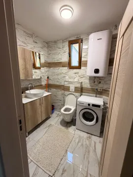 Moderno opremljeno kupatilo sa umivaonikom, wc šoljom i veš mašinom. - image 6