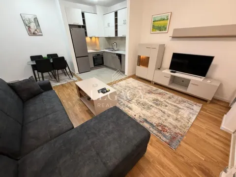 Living room with a sofa and dining area in an open-plan layout. - image 7