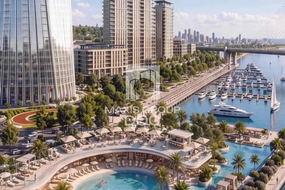 View of a modern development with a marina and landscaped waterfront.