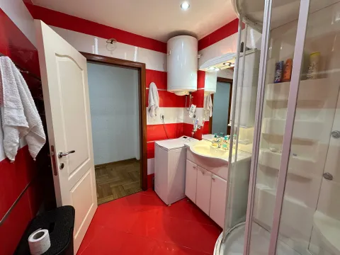Bathroom with shower cabin, washbasin, water heater, and washing machine. - image 7