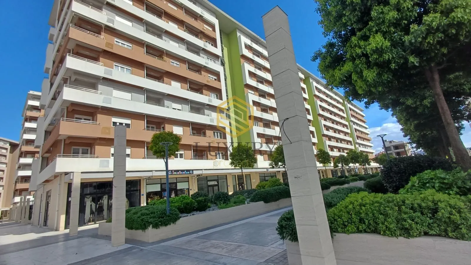 Exterior view of an apartment building with a landscaped yard.