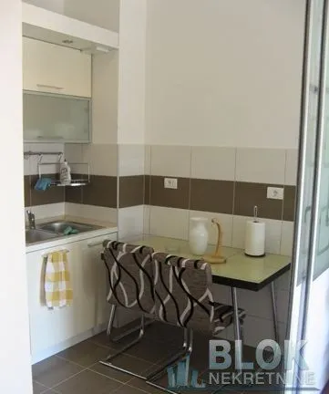 Small kitchen with a dining table and two chairs.