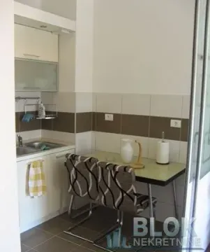 Small kitchen with a dining table and two chairs. - image 10