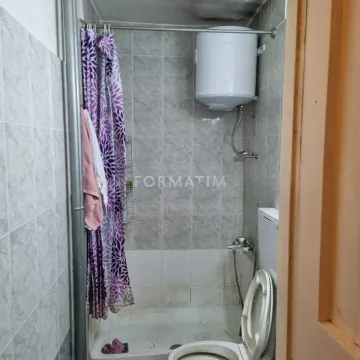 Small bathroom with a shower cabin and water heater. - image 4