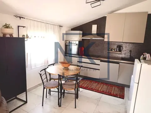 Kitchen with a dining table and chairs near the window. - image 2