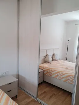 View of the bedroom with a double bed and a large mirrored wardrobe. - image 4