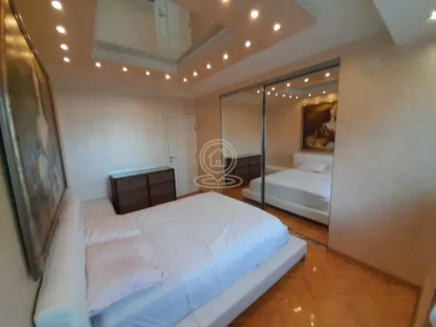 Spacious bedroom with a double bed and a large built-in mirrored wardrobe. - image 11