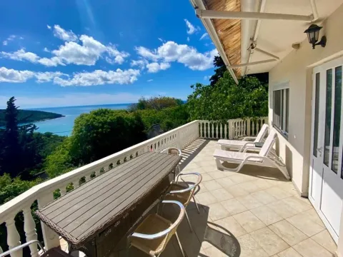 Spacious terrace with patio furniture, sun loungers, and a sea view. - image 4