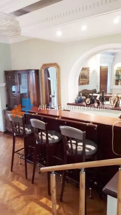 Living room with a bar counter and wooden furniture.