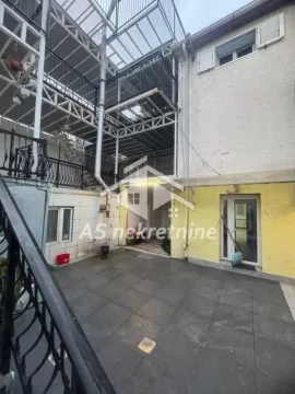 View of the paved courtyard and exterior stairs of a multi-story building. - image 33