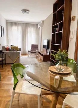 Living room with dining area and sofa. - image 8