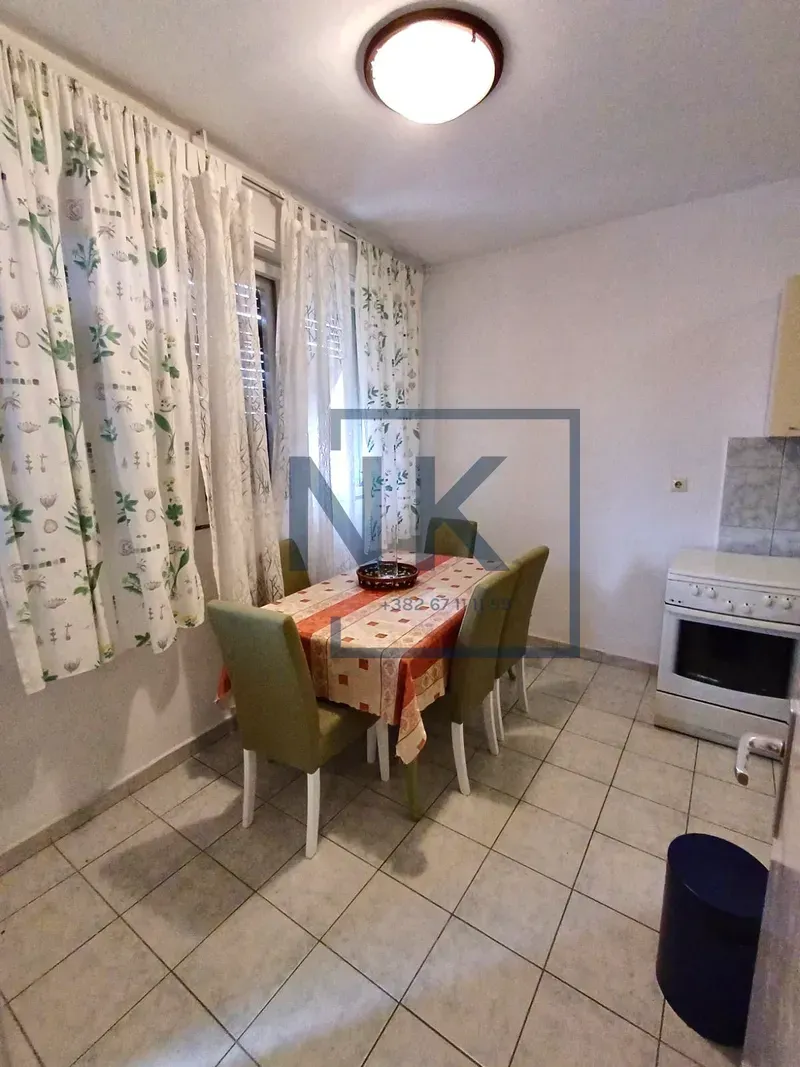 Kitchen with a dining table and chairs by the window.