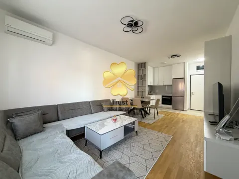 Living room with a sofa connected to the dining area and kitchen. - image 2