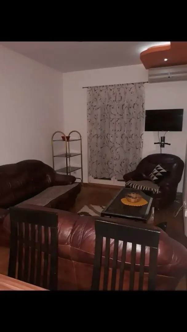 Living room with leather furniture and a TV.