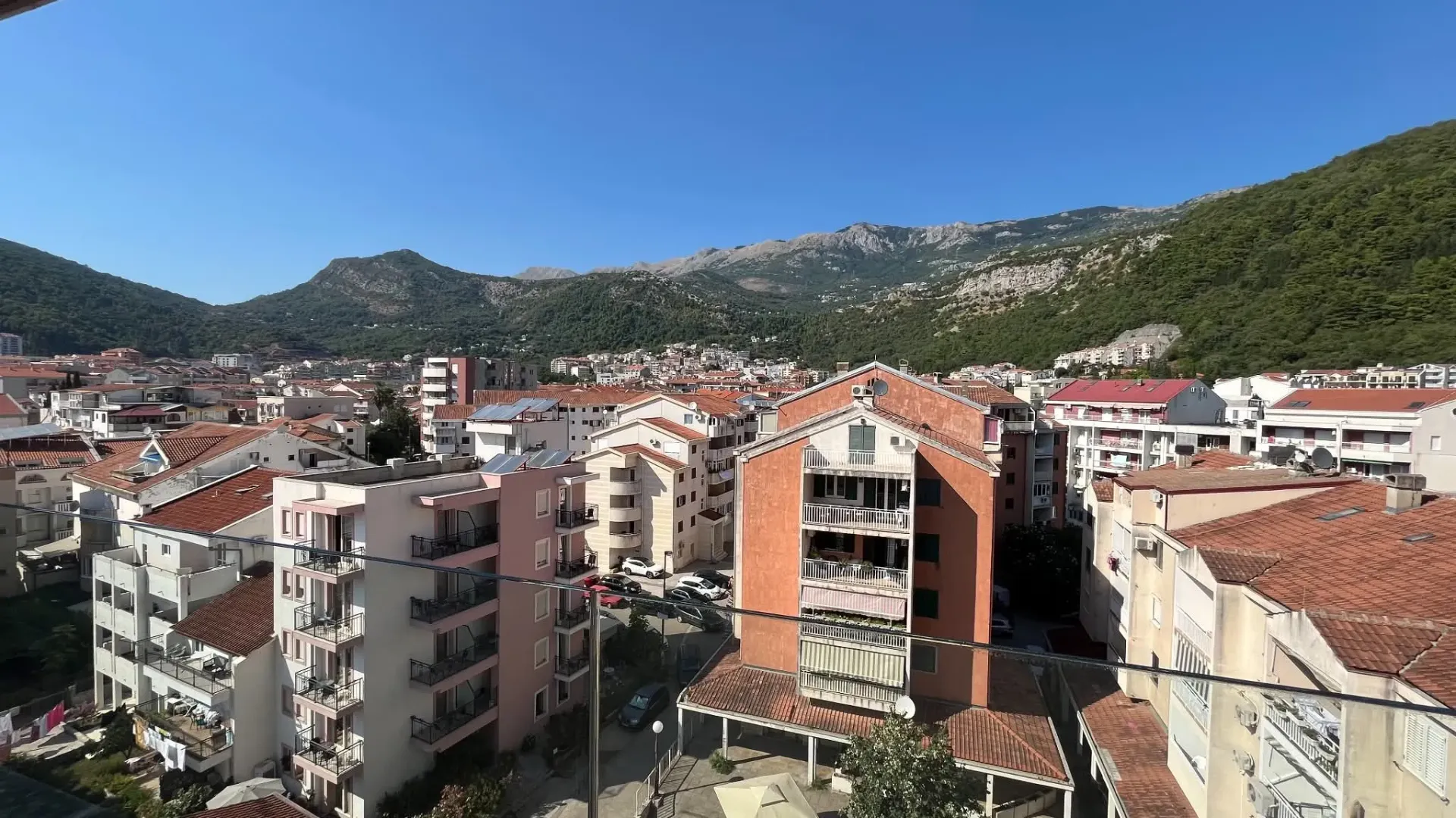 View from the terrace towards the city and mountains in the background.