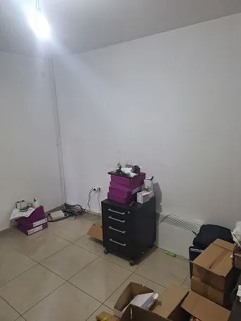 Empty room with boxes and an office cabinet.