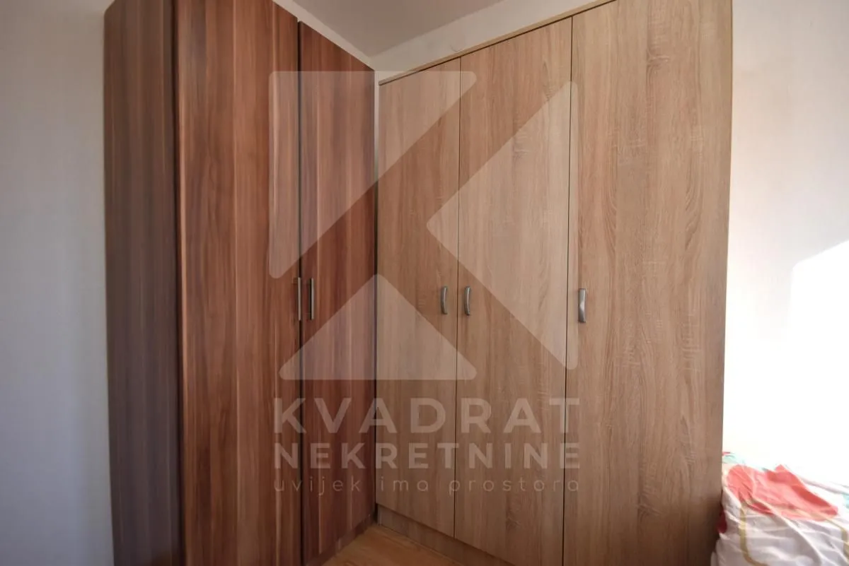 Bedroom with large wooden wardrobes.