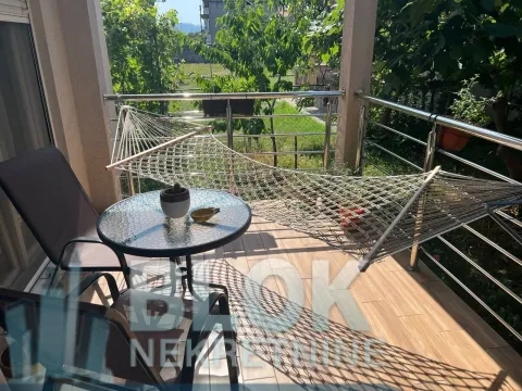 Furnished terrace with a table, chairs, and a hammock. - image 6