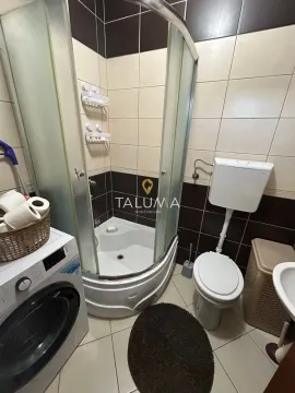 Bathroom equipped with a shower cabin, toilet and washing machine. - image 5
