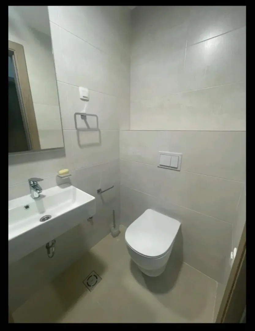 Manje kupatilo sa umivaonikom i ugradnom wc šoljom.