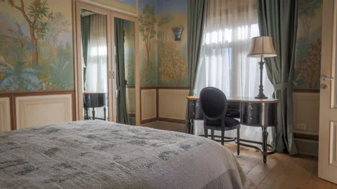 Spavaća soba sa krevetom, radnim stolom i oslikanim zidovima. - image 15