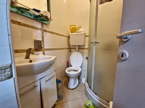 Smaller bathroom with a washbasin, toilet, and shower cabin. - image 5